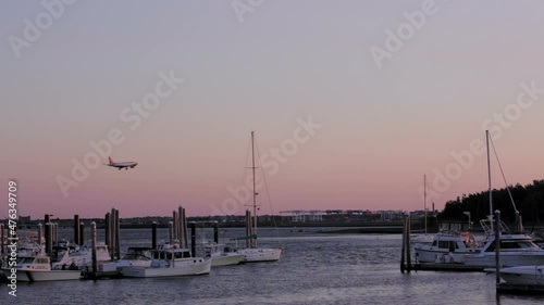 plane lands at boston logan airport viewed from yacht club wide