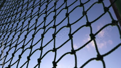 The protective net is in the baseball field.