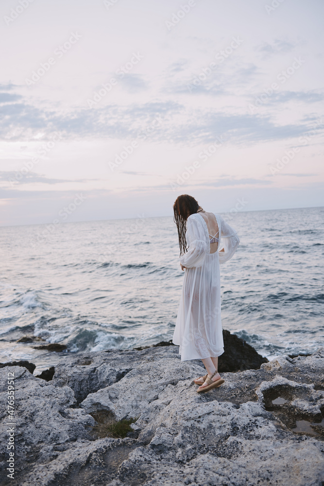 Attractive woman walks volcanic rock formations on the island Lifestyle Attractive woman walks volcanic rock formations on the island Lifestyle