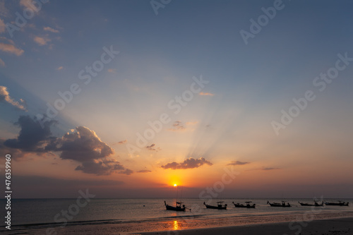 Lanscape of longtail boat in evening time with sunray beam