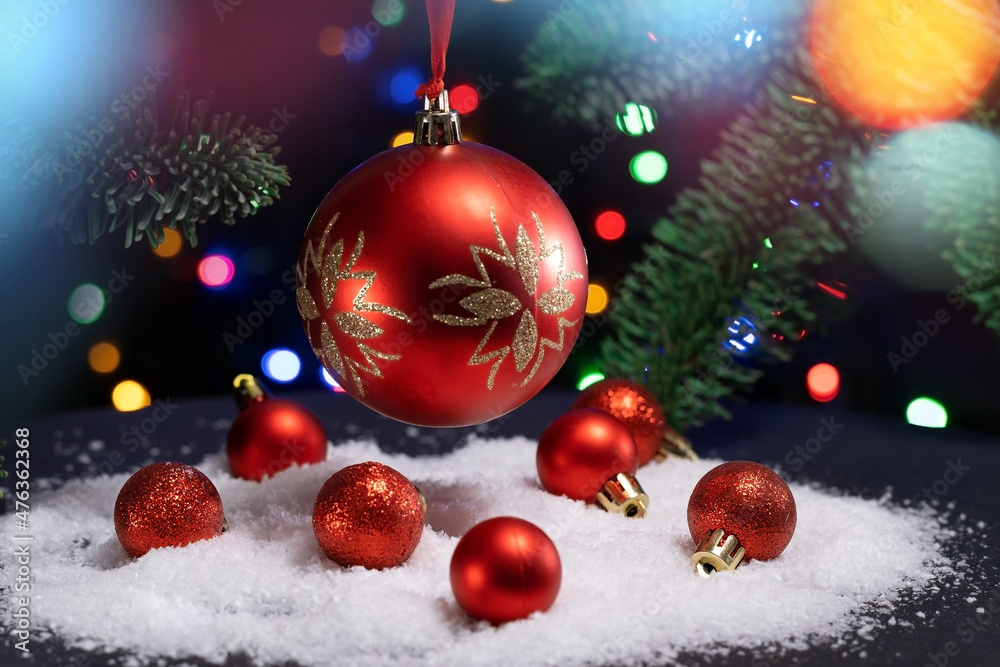New Year red ball toys on bokeh background. Christmas Decoration. Abstract Blurred Bokeh Holiday Background. Christmas Tree Lights Twinkling. red Christmas tree toy on the snow New Year red ball toys on bokeh background. Christmas Decoration. Abstract Blurred Bokeh Holiday Background. Christmas Tree Lights Twinkling. red Christmas tree toy on the snow