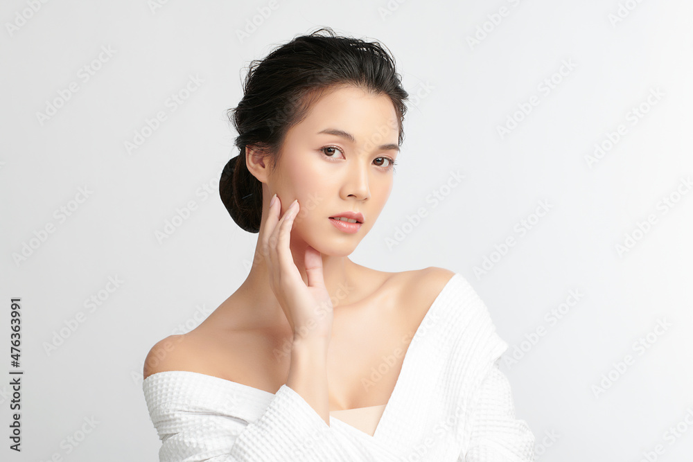 Beautiful young Asian woman wearing bathrobe on white background, Face care, Facial treatment, Cosmetology, beauty and spa Concept. Beautiful young Asian woman wearing bathrobe on white background, Face care, Facial treatment, Cosmetology, beauty and spa Concept.