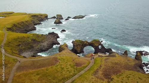 Amazing seascape, Gatklettur basalt rock arch at the volcanic cliff, Atlantic coast of Arnarstapi in the west of Iceland, natural background. Rocks and stones with abstract forms. Drone footage. 