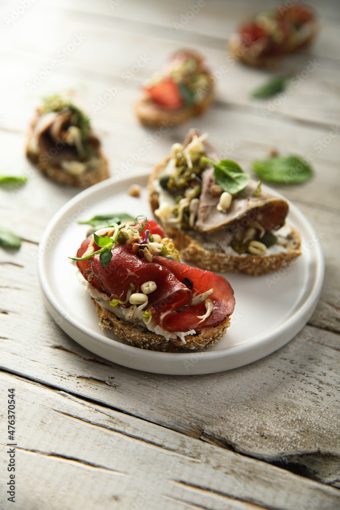 Homemade bruschetta with meat and cream cheese