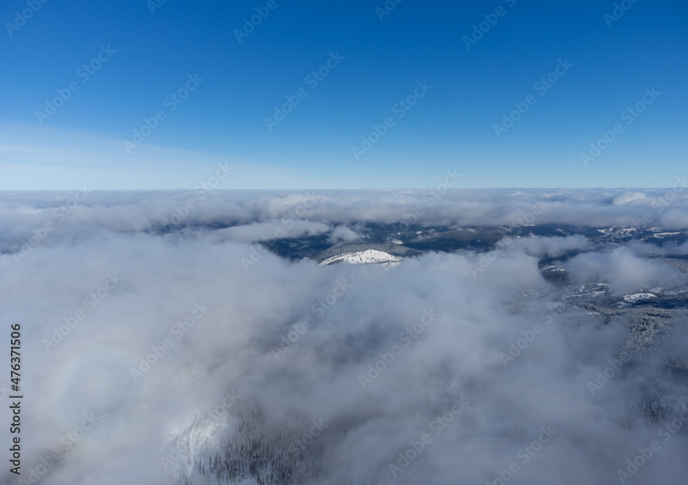 Landscape above the clouds with blue sky