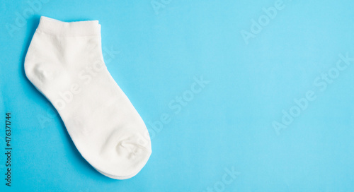 White socks on blue background and space for text.