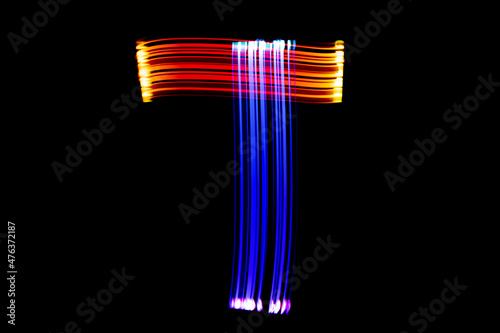 Letter T. Isolated figure on a black background. Freezelight.