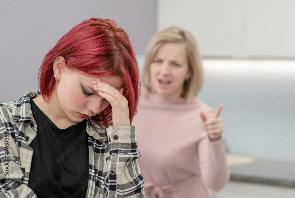 Family conflict. Angry woman screams at guilty teen daughter Family conflict. Angry woman screams at guilty teen daughter