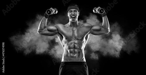 Happy man athlete with dumbbell on black background. Gym full body workout. Muscular man athlete in fitness gym have havy workout. Sports trainer on trainging. Fitness motivation. photo