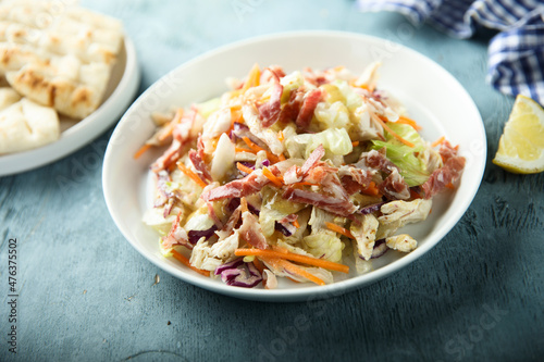 Coleslaw salad with bacon served with pita bread