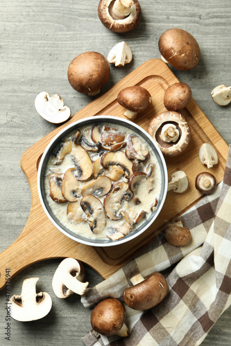 Concept of tasty food with mushroom sauce on gray wooden background