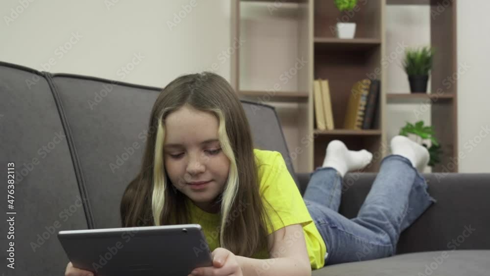 Lucky girl watching videos on her tablet computer Lucky girl watching videos on her tablet computer