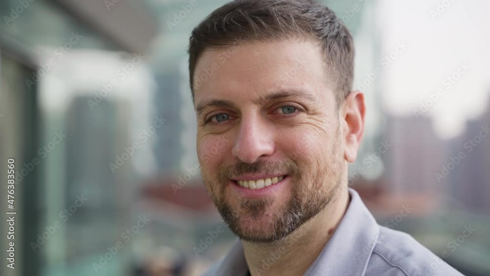 portrait of happy 30s beard man looking at camera smile Confidence businessman in urban background portrait of happy 30s beard man looking at camera smile Confidence businessman in urban background