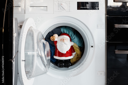 Santa Claus in the washing machine. Christmas.
