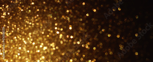 background of abstract gold and black glitter lights. defocused © tomertu