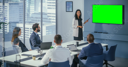 Diverse Office Conference Room Meeting  Asian Female Project Manager Uses Green Screen Chroma Key Wall TV to Present Digital Investment Opportunity for Happy Investment Team.