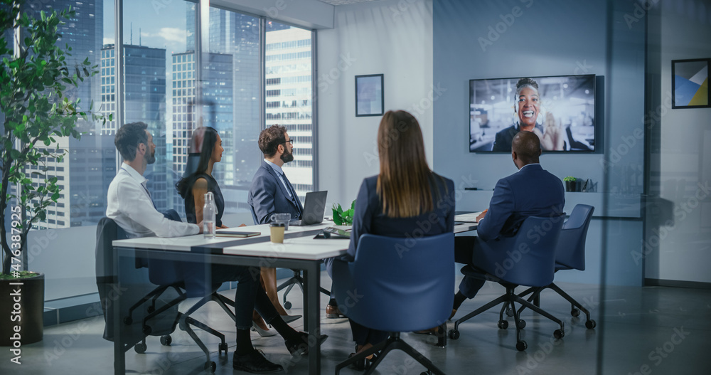 Video Conference Call in Office Meeting Room: Black Female Executive Talks with Group of Multi-Ethnic Digital Entrepreneurs, Managers, Investors. Businesspeople Discuss e-Commerce Investment Strategy