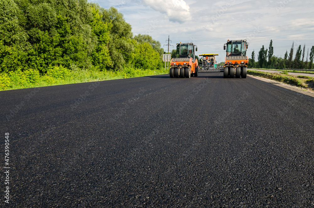 Laying a new asphalt on the road. Construction of the road. Laying a new asphalt on the road. Construction of the road.