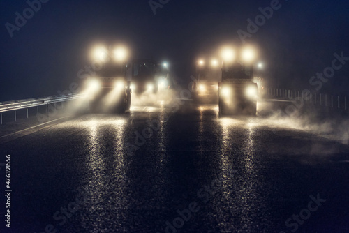 Rolling asphalt at night with headlights. Road construction.