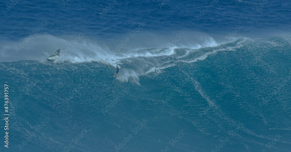 Fototapeta premium Sport photography. Jaws swell on International surfing event in Maui, Hawai 2021 December.