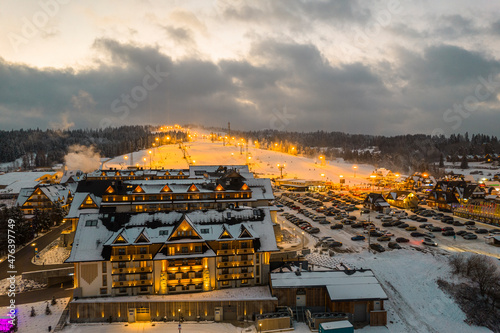 Bania Hotel and Ski Resort in Bialka, Poland at Winter. Drone View at Night