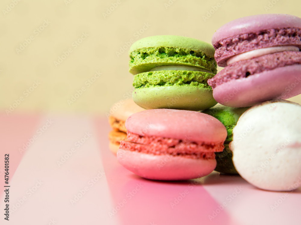 Fresh baked colored macaroon cookies macarons, macarons on a white plate close-up, Fresh baked colored macaroon cookies macarons, macarons on a white plate close-up,
