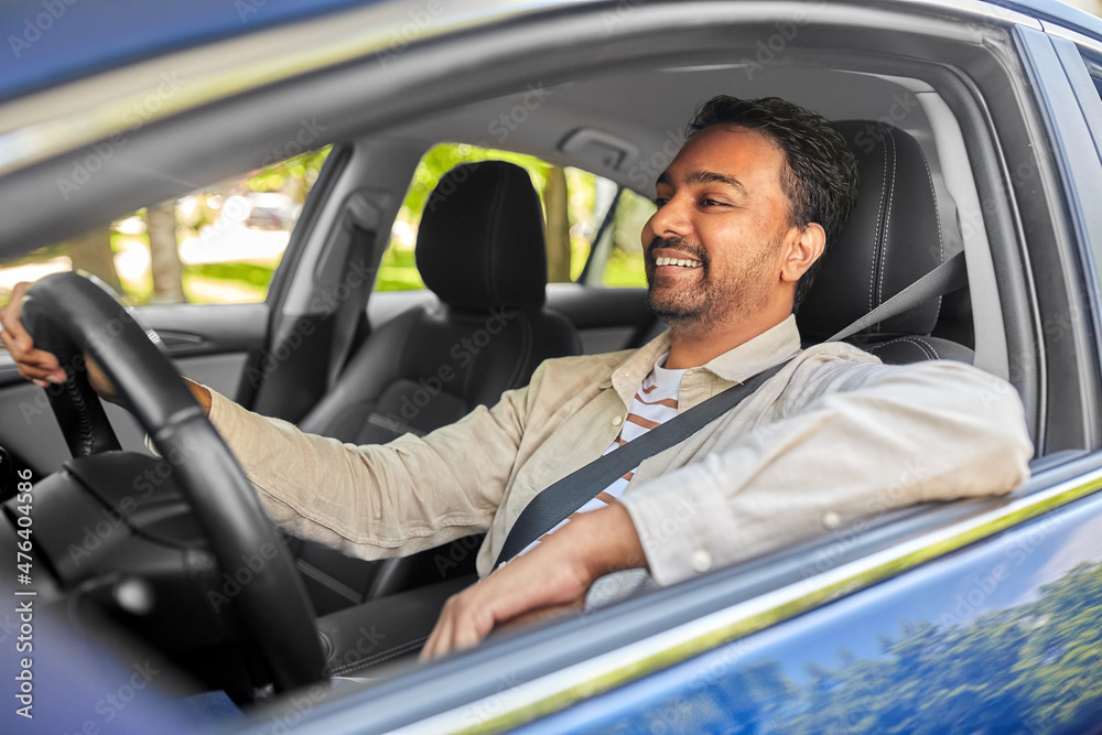 transport, vehicle and people concept - happy smiling indian man or driver driving car