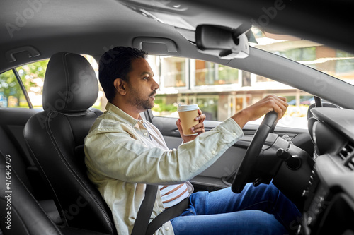 transport, vehicle and people concept - indian man or driver with takeaway coffee cup driving car © Syda Productions