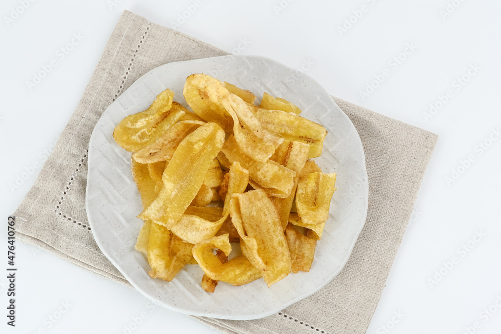 Heap of dried banana chips snack on white background. Selective focus image, blurred background.
Heap of dried banana chips snack on white background. Selective focus image, blurred background.