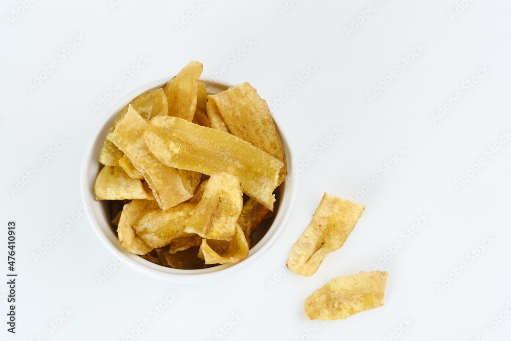 Heap of dried banana chips snack on white background. Selective focus image, blurred background.
Heap of dried banana chips snack on white background. Selective focus image, blurred background.