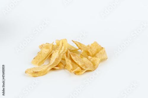 Heap of dried banana chips snack on white background. Selective focus image, blurred background.

