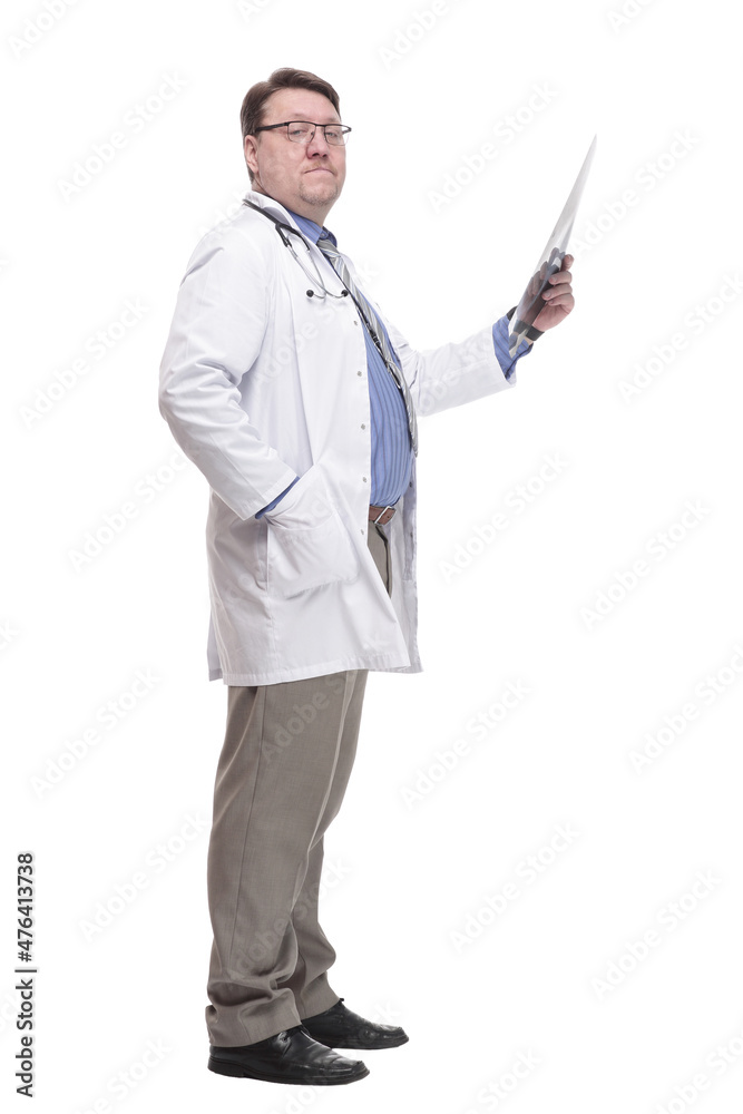 in full growth. serious doctor looking at an x-ray. in full growth. serious doctor looking at an x-ray.