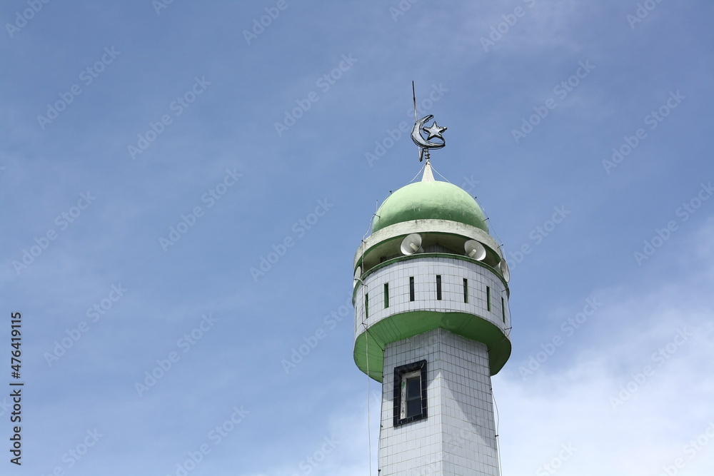 mosque tower against blue sky