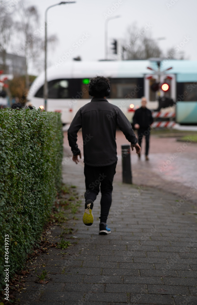 Fototapeta premium a guy running with a train in the background