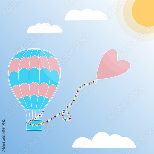 Aerostat with a heart on a string with flags flying towards the sun. Hot air balloon in the sunny sky