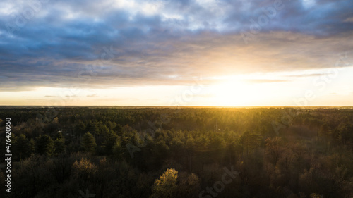 Beautiful sunset over a river with green bushes and color rich sky. High quality photo