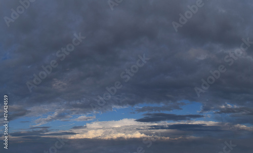 Late evening, impending, powerful thunderclouds.
Panoramic photography, the image is horizontally elongated, atmospheric phenomenon.
