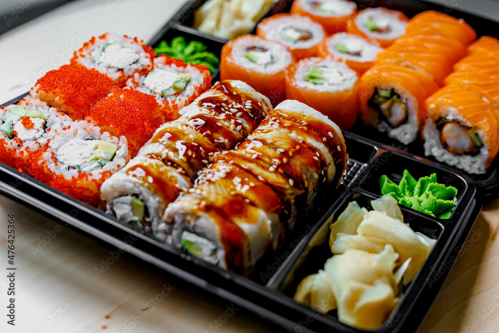Japanese sushi food. Maki ands rolls with tuna, salmon, shrimp, crab and avocado. Top view of assorted sushi. Rainbow sushi roll, uramaki, hosomaki and nigiri. Japanese sushi food. Maki ands rolls with tuna, salmon, shrimp, crab and avocado. Top view of assorted sushi. Rainbow sushi roll, uramaki, hosomaki and nigiri.