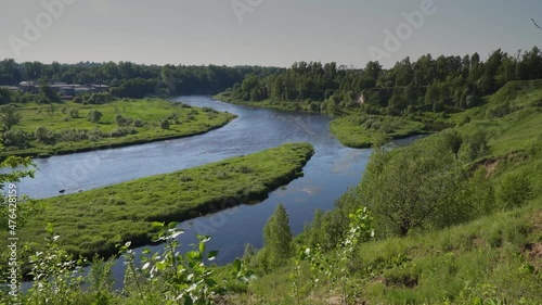 Russia. June 20, 2021. Novgorod region. Picturesque view of the Msta River near the town of Borovichi in sunny weather from the high bank.