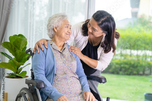 Caregiver daughter help Asian senior or elderly old lady woman sitting on wheelchair.