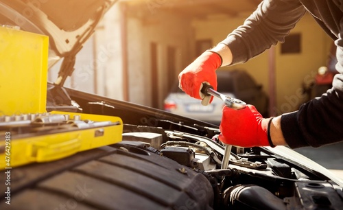 car mechanic holding wrench key isolated