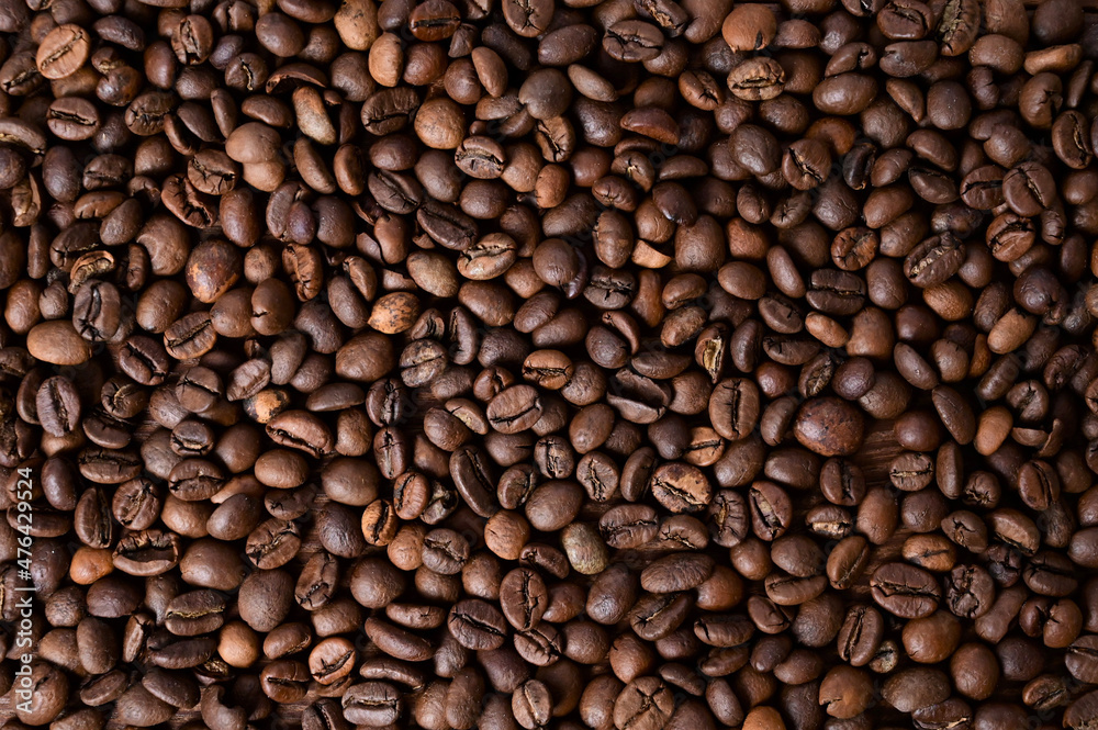 Coffee bean background. Roasted coffee beans on a wooden table. Brown coffee. Top view Coffee bean background. Roasted coffee beans on a wooden table. Brown coffee. Top view
