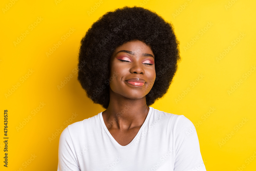 Photo of relaxed afro american young joyful woman closed eyes smile isolated on yellow color background Photo of relaxed afro american young joyful woman closed eyes smile isolated on yellow color background