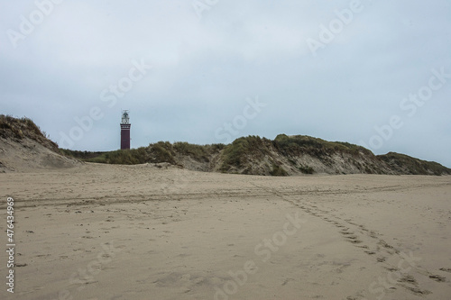 lighthouse in the dunes near the sandy beach of Ouddorp at the Northsea coast © henkbouwers