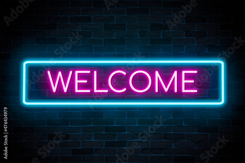 Welcome neon banner on a brick wall.