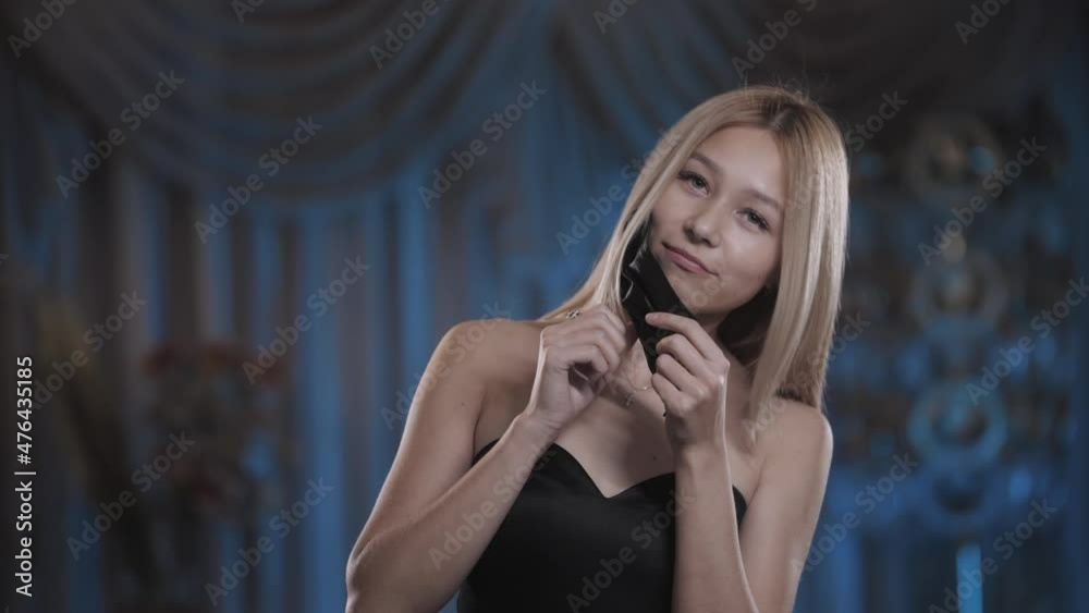 beautiful girl in a dress putting on a medical mask. Pandemic, covid-19 beautiful girl in a dress putting on a medical mask. Pandemic, covid-19