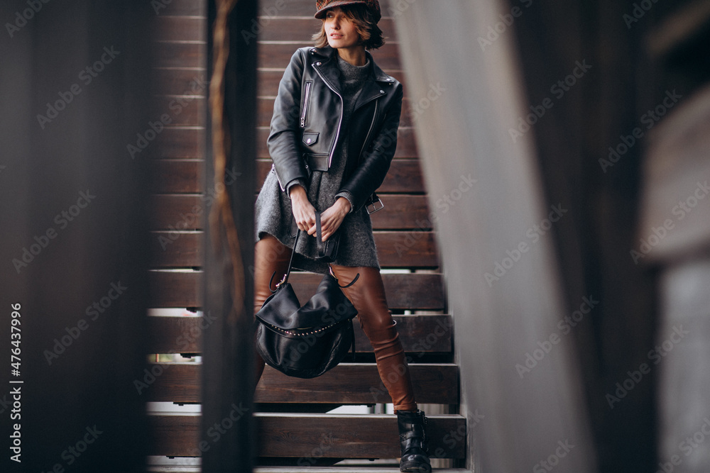 Young beautiful woman in leather jacket outside the street