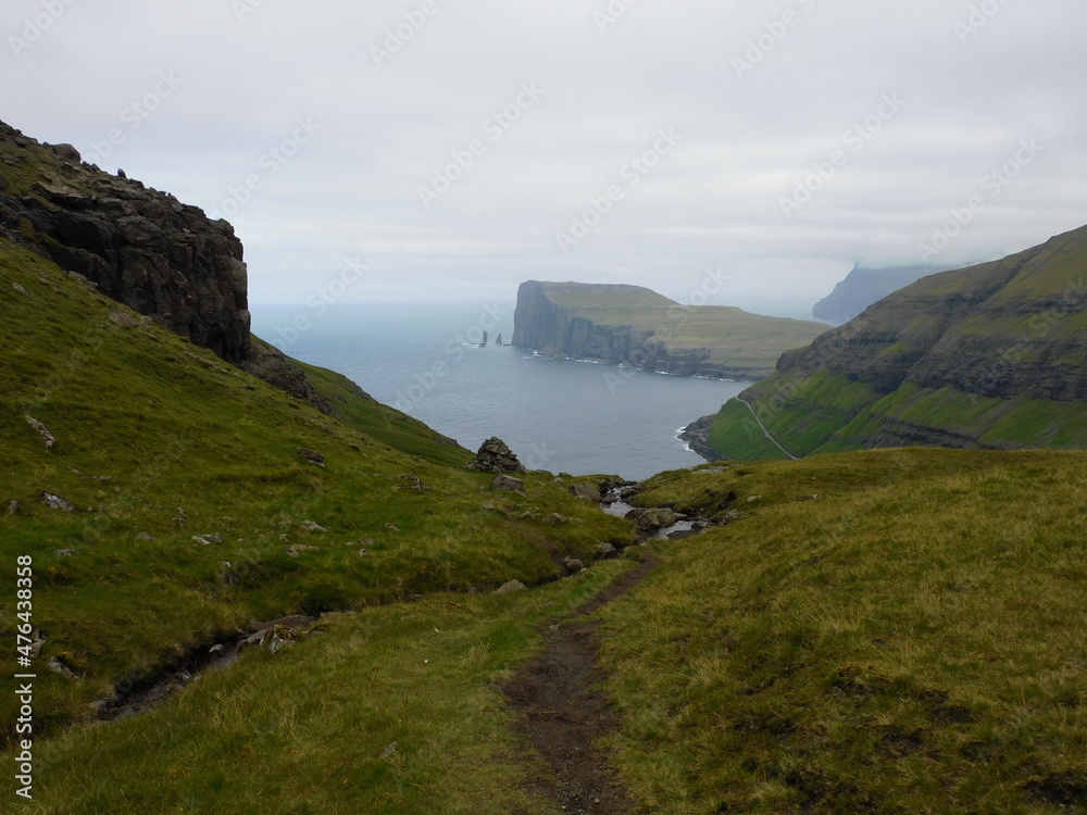 The beautiful Atlantic coastline and islets on the Faroe Islands The beautiful Atlantic coastline and islets on the Faroe Islands