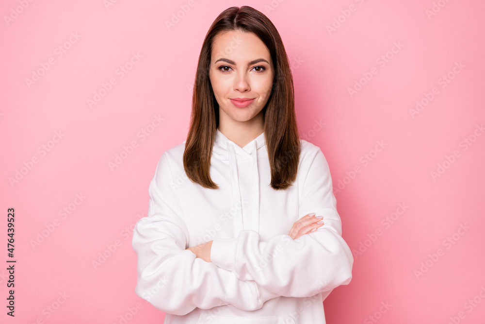 Photo of good millennial brunette lady crossed arms wear white hoodie isolated on pink color background Photo of good millennial brunette lady crossed arms wear white hoodie isolated on pink color background