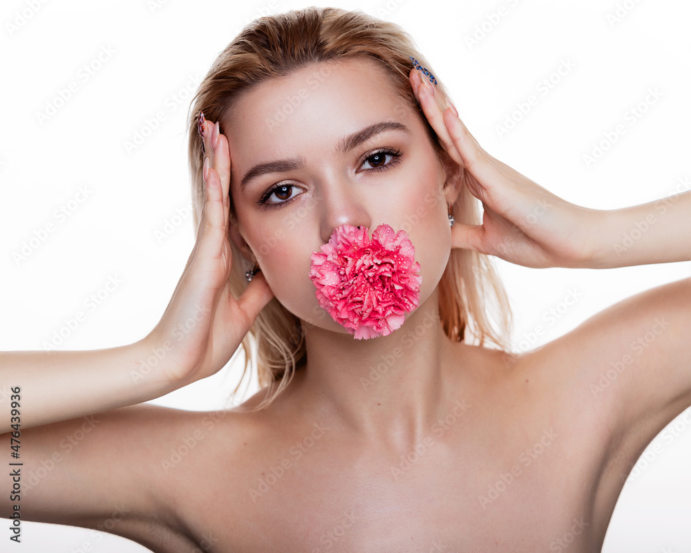 Charming young woman with pink flower in the mouth. Blonde model holding pink flower isolated over white background. Concept of beauty and health care free space for text Charming young woman with pink flower in the mouth. Blonde model holding pink flower isolated over white background. Concept of beauty and health care free space for text